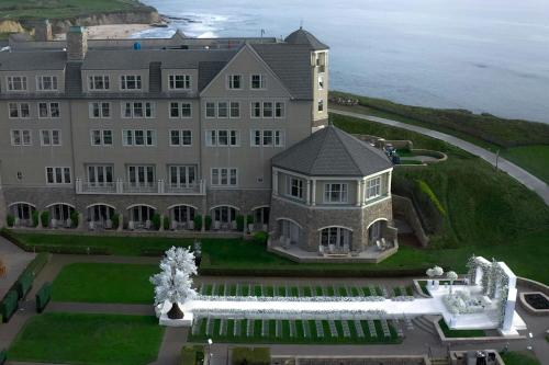 an aerial view of a building with the ocean in the background at The Ritz-Carlton, Half Moon Bay in Half Moon Bay