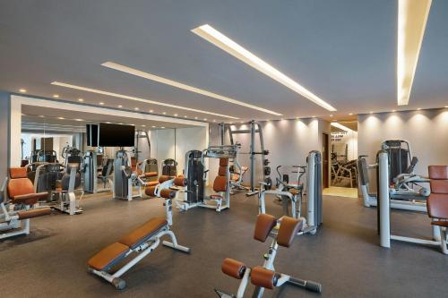 a gym with a lot of machines and a flat screen tv at Four Points by Sheraton Al Ain in Al Ain
