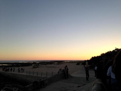 a group of people on the beach at sunset at Mamaisondouce in Saint-Clément-des-Baleines