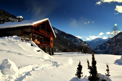 a snow covered cabin in the mountains with snow at Maison Tissiere in Antey-Saint-André