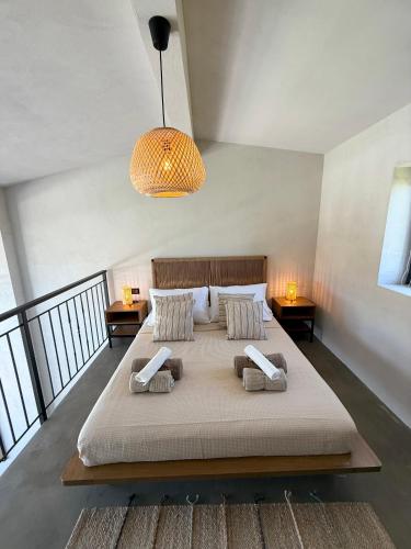 a bedroom with a large bed with two pillows at STELIA Villa Halkidiki in Kallithea Halkidikis