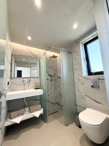a bathroom with a toilet and a sink and a shower at STELIA Villa Halkidiki in Kallithea Halkidikis