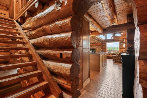 a staircase in a log cabin with wooden walls at Log Retreat at Fish Creek by Simple Life Rentals in Fish Creek