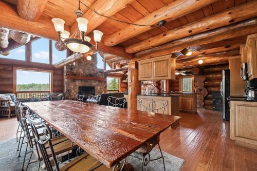 a large dining room with a large wooden table at Log Retreat at Fish Creek by Simple Life Rentals in Fish Creek