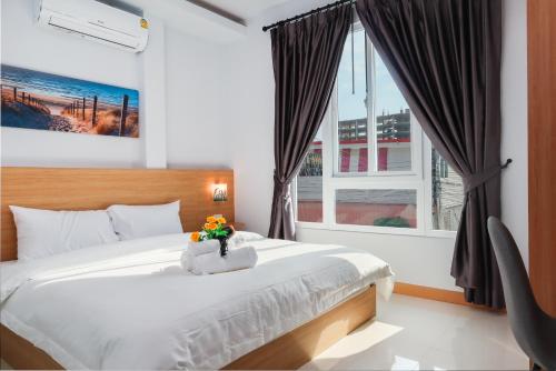 a bedroom with a bed and a large window at Pattaya Luxury Villa, 5BR 6BA, Private Pool with Jacuzzi Cityhouse54 in Pattaya South