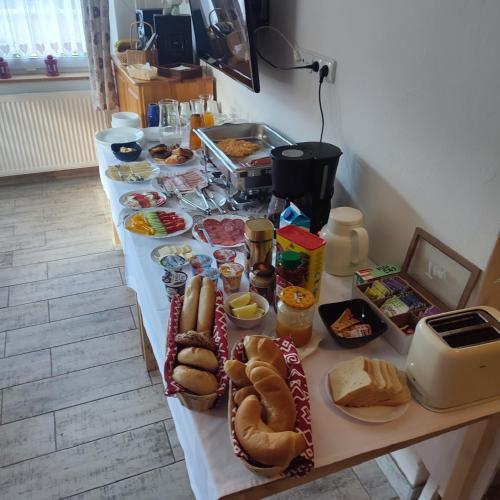 a table with hot dogs and other food on it at Villa Tatran in Stará Lesná