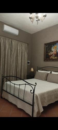 a bedroom with a bed with a white bedspread at Antica Residenza Voso in Laureana Cilento