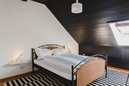 a bedroom with a bed with a black wall at Auberge d'Ajoie in Porrentruy