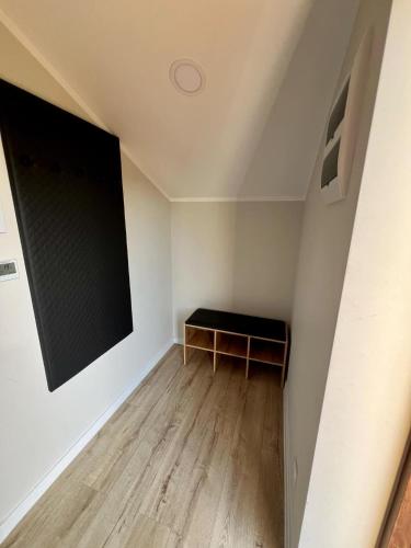 a small room with a black board on the wall at Apartament ARKON in Hermanowa