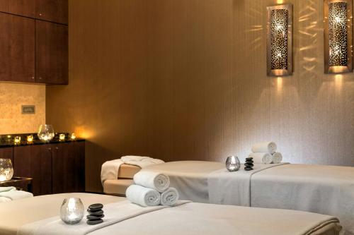 a room with three beds with white sheets at Grand Hotel River Park, a Luxury Collection Hotel, Bratislava in Bratislava