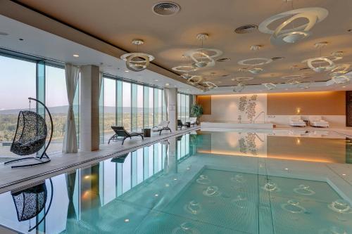 a swimming pool in a house with a large window at Grand Hotel River Park, a Luxury Collection Hotel, Bratislava in Bratislava