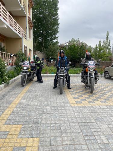 a group of people on motorcycles parked next to a building at Zlatan Guest House in Leh