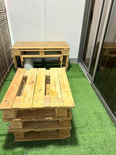 a wooden bench sitting on top of green grass at Residence Sunset 3 bedrooms appartment in Midlands Station