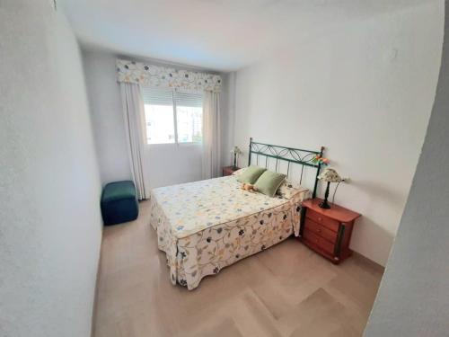 a bedroom with a bed and a window at Apartamento Aiguablava Playa de Gandía in Playa de Gandia