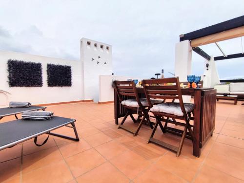 a room with chairs and a table on a roof at Casa de la Sonrisa in Alhama de Murcia
