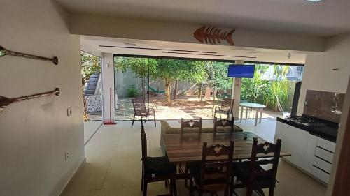 a kitchen and dining room with a table and chairs at Casa de praia em Itaúna, Saquarema, Pertinho do mar 150 m da areia com 3 quartos e ar condicionado in Saquarema