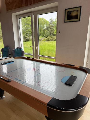 a ping pong table sitting in a room with at Oaza Spokoju Pod Warszawą in Marianka