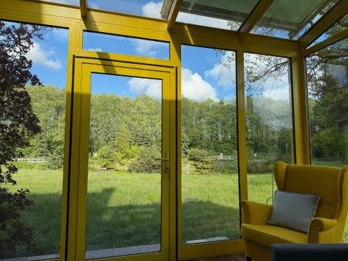 a screened in porch with a view of a field of grass at Oaza Spokoju Pod Warszawą in Marianka