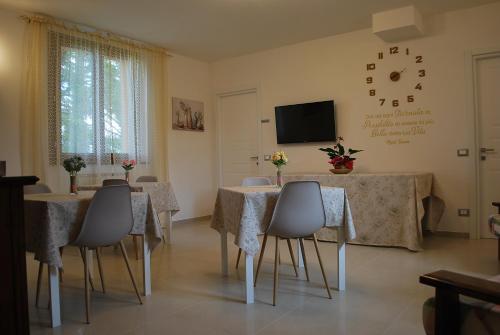 a dining room with tables and chairs and a tv at B&B Terra Camerte in Camerino