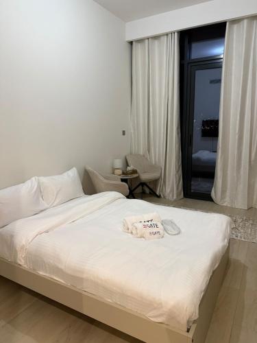 Un dormitorio con una cama con una toalla encima. en EGATE - Studio - 10th Floor - Balcony with a View - 01-1014, en Dubái
