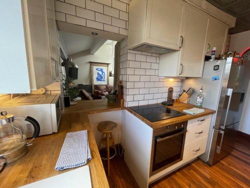 a kitchen with white cabinets and a counter top at LiverpoolPenny Lane in Liverpool