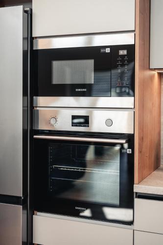 a black and silver oven in a kitchen at Rezidence Magnolie in Velké Pavlovice