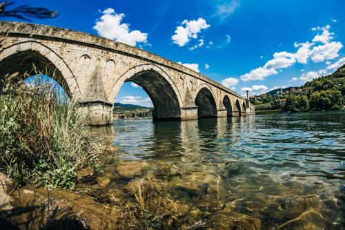 a bridge over the water on a sunny day at Kanjon 987 in Podgrad