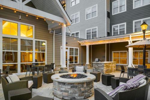 an outdoor patio with a fire pit and tables and chairs at Residence Inn by Marriott Albany Clifton Park in Clifton Park