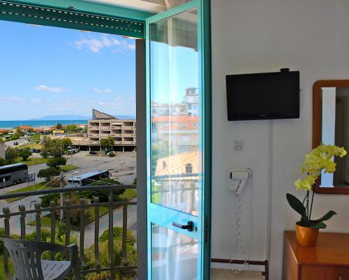 a sliding glass door with a view of a city at Hotel Puccinelli in Lido di Camaiore