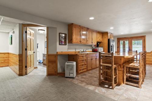 a kitchen with wooden cabinets and a wooden table at Log Retreat at Fish Creek by Simple Life Rentals in Fish Creek