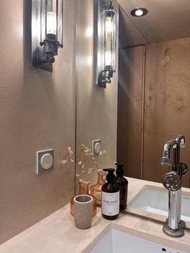 a bathroom counter with a sink and a mirror at the Workshop in Plomarion