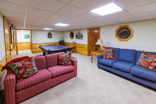 a living room with two couches and a piano at Log Retreat at Fish Creek by Simple Life Rentals in Fish Creek