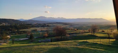 a view of a valley with mountains in the distance at Planinski san in Žabljak
