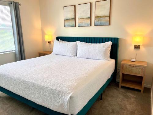 a bedroom with a bed with two night stands and two lamps at Private Beach-Private Pool-Easy walk to the Beach in Gulf Highlands