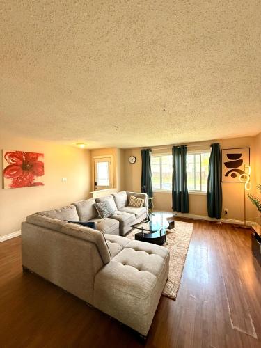 a living room with a couch and a table at The house Londonderry mall in Edmonton
