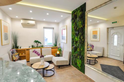 a living room with a table and chairs and a mirror at Cozy Villa withy yard and private parking in Belgrade