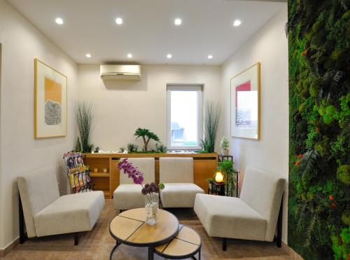 a living room with two chairs and a table at Cozy Villa withy yard and private parking in Belgrade