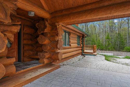 an exterior view of a log cabin with a porch at Log Retreat at Fish Creek by Simple Life Rentals in Fish Creek