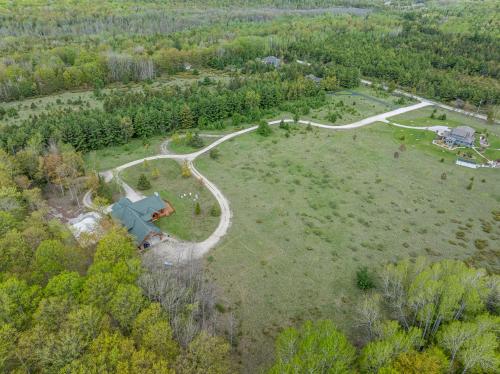 an aerial view of a house in a field at Log Retreat at Fish Creek by Simple Life Rentals in Fish Creek
