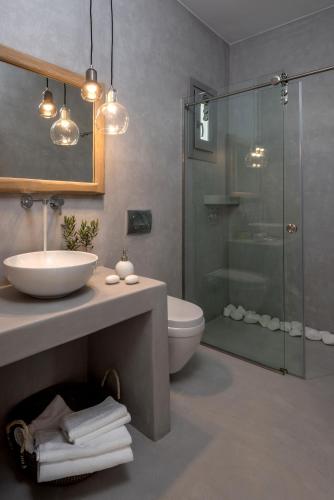 a bathroom with a sink and a toilet and a shower at Seven Suites in Glinado Naxos