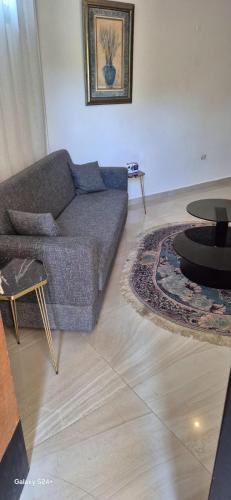 a living room with a couch and a table at Aley Pilot Residence in Al Qammāţīyah