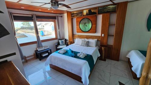 a bedroom of a boat with a bed and a window at Casa Ocean Pier in Puerto Ayora