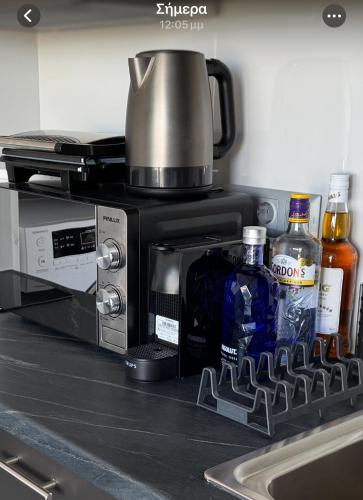 a kitchen counter with a coffee maker on top of a microwave at Rooftop with 360 view in Athens
