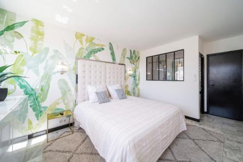 - une chambre avec un lit blanc et une plante dans l'établissement -CLR- Charming 3-Bedroom Apartment in the Heart of Cannes, à Cannes