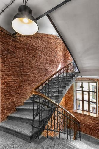 a staircase in a brick wall with a ceiling at Cinema Rooms - Piotrkowska in Łódź