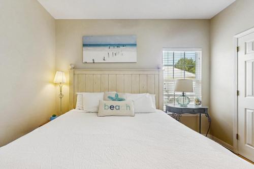 a bedroom with a bed with a pillow on it at Down the Shore in Gulf Shores