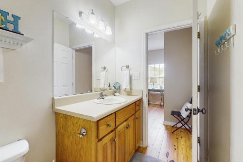 a bathroom with a sink and a mirror at Down the Shore in Gulf Shores