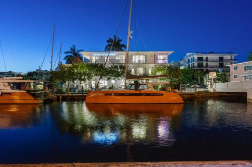 an orange boat in the water in front of a building at Isle of Venice Residence and Marina in Fort Lauderdale