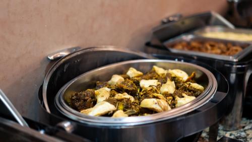 a pot full of food on a stove at Palais Du Desert Hotel & Spa in Erfoud