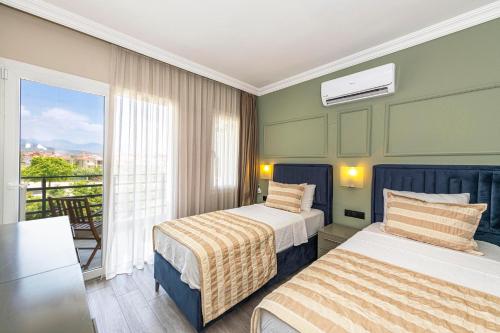 Postel nebo postele na pokoji v ubytování IDEE SUİTES Fethiye